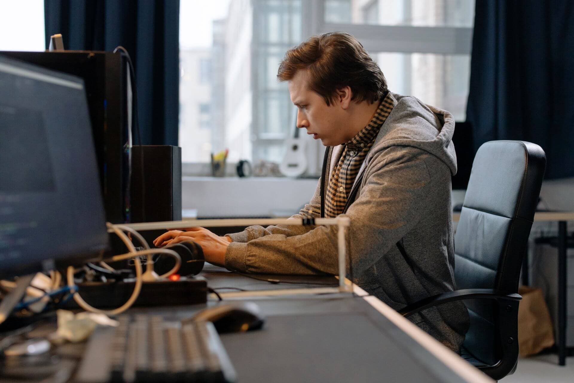 Cybersecurity professional monitoring security systems at a workstation